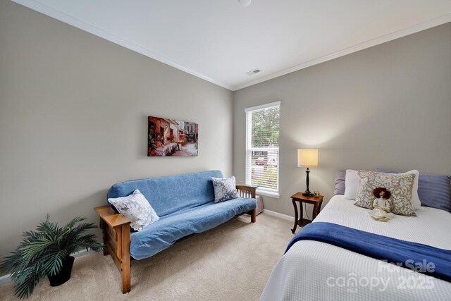 bedroom featuring visible vents, crown molding, baseboards, and light carpet