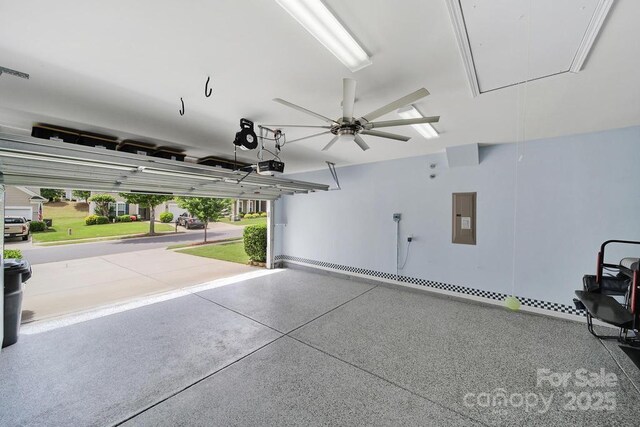 garage with ceiling fan, electric panel, and a garage door opener