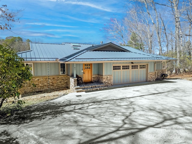 61 Tsataga Ct, Brevard, NC 28712 - view of front of home with an attached garage, board and batten siding, metal roof, and stone siding