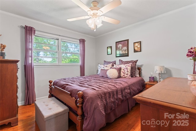 bedroom with baseboards, a ceiling fan, wood finished floors, and ornamental molding