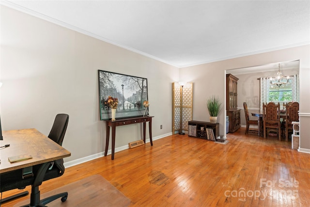 office space featuring baseboards, light wood-style floors, a chandelier, and ornamental molding