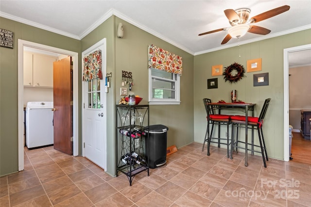 dining room featuring ceiling fan, ornamental molding, and washer / dryer