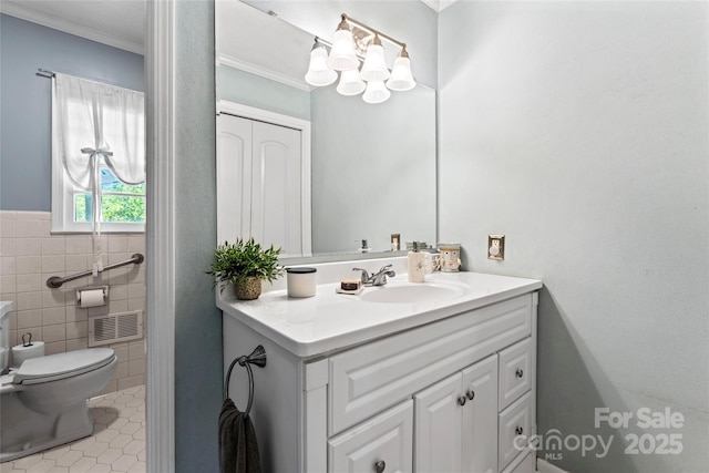 bathroom with tile patterned floors, visible vents, toilet, vanity, and crown molding