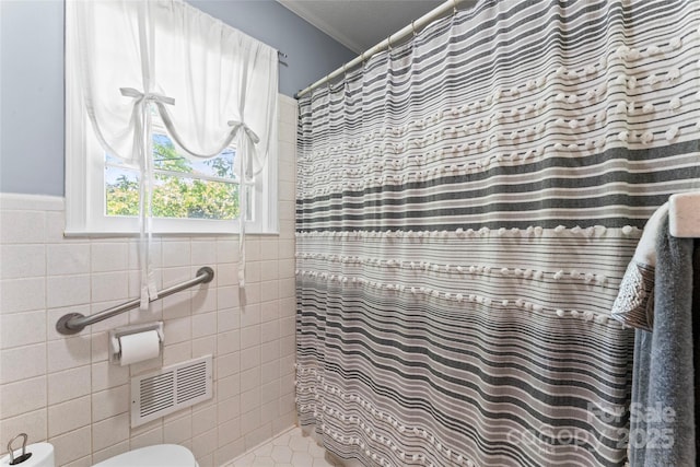 full bathroom featuring tile walls, visible vents, crown molding, and a shower with curtain