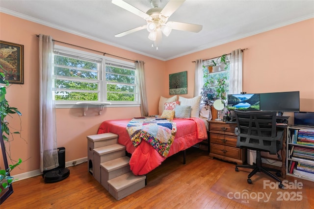 bedroom featuring hardwood / wood-style flooring, ceiling fan, baseboards, and ornamental molding