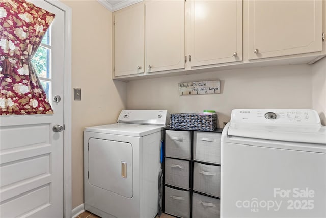 clothes washing area featuring cabinet space and washer and dryer