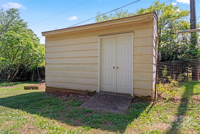 view of shed with fence