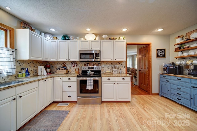 122 Roxboro Ct Unit 286, Mount Gilead, NC 27306 - kitchen with white cabinets, stainless steel appliances, a textured ceiling, and backsplash