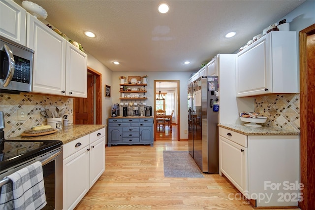122 Roxboro Ct Unit 286, Mount Gilead, NC 27306 - kitchen with white cabinets, stainless steel appliances, recessed lighting, and light wood finished floors