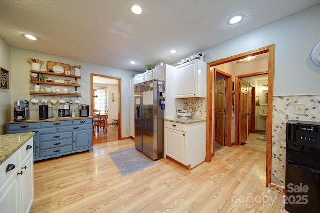 122 Roxboro Ct Unit 286, Mount Gilead, NC 27306 - kitchen featuring light stone countertops, light wood finished floors, white cabinetry, recessed lighting, and fridge with ice dispenser