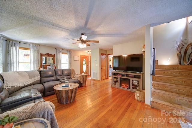 122 Roxboro Ct Unit 286, Mount Gilead, NC 27306 - living room with a textured ceiling, visible vents, ceiling fan, and light wood finished floors