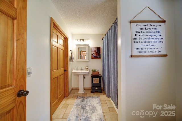 122 Roxboro Ct Unit 286, Mount Gilead, NC 27306 - full bath featuring stone tile flooring, baseboards, a textured ceiling, and a shower with shower curtain