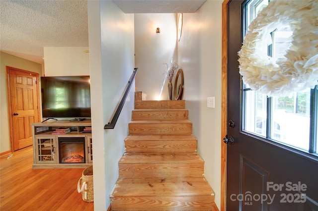 122 Roxboro Ct Unit 286, Mount Gilead, NC 27306 - stairway featuring a textured ceiling and wood finished floors