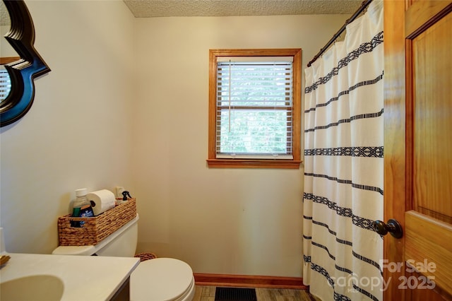 122 Roxboro Ct Unit 286, Mount Gilead, NC 27306 - bathroom with vanity, toilet, a textured ceiling, baseboards, and visible vents