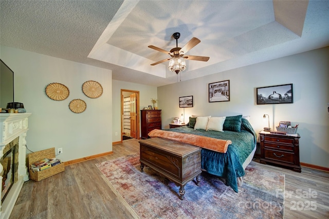 122 Roxboro Ct Unit 286, Mount Gilead, NC 27306 - bedroom featuring baseboards, a tray ceiling, ceiling fan, and wood finished floors