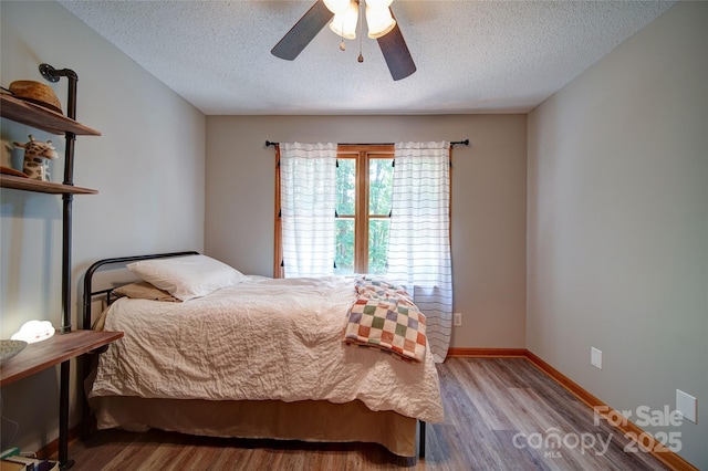 122 Roxboro Ct Unit 286, Mount Gilead, NC 27306 - bedroom with a ceiling fan, a textured ceiling, and wood finished floors