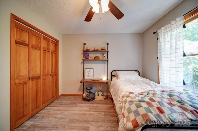 122 Roxboro Ct Unit 286, Mount Gilead, NC 27306 - bedroom with a closet, baseboards, ceiling fan, light wood-type flooring, and a textured ceiling