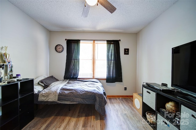 122 Roxboro Ct Unit 286, Mount Gilead, NC 27306 - bedroom featuring a ceiling fan, a textured ceiling, baseboards, and light wood-type flooring