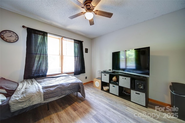 122 Roxboro Ct Unit 286, Mount Gilead, NC 27306 - bedroom with a textured ceiling, baseboards, a ceiling fan, and wood finished floors