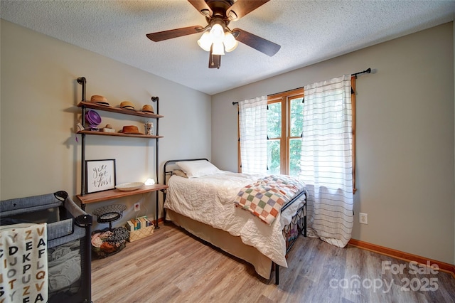 122 Roxboro Ct Unit 286, Mount Gilead, NC 27306 - bedroom with light wood-style floors, baseboards, ceiling fan, and a textured ceiling