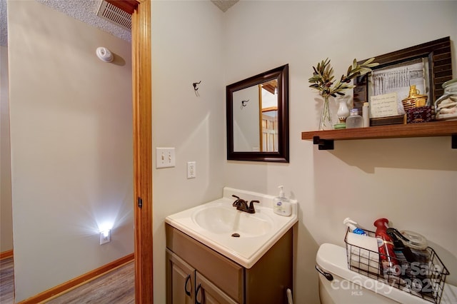 122 Roxboro Ct Unit 286, Mount Gilead, NC 27306 - bathroom featuring vanity, baseboards, wood finished floors, and toilet