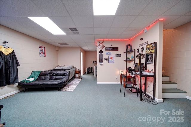 122 Roxboro Ct Unit 286, Mount Gilead, NC 27306 - carpeted living area with concrete block wall, baseboards, and a paneled ceiling