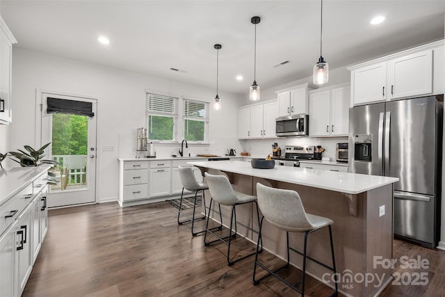 1024 Scotch Meadows Loop Unit 32, Monroe, NC 28110 - kitchen featuring appliances with stainless steel finishes, recessed lighting, white cabinetry, a center island, and a breakfast bar area
