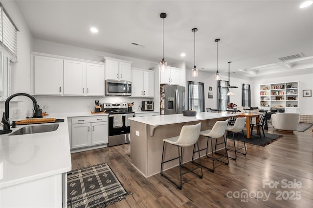 1024 Scotch Meadows Loop Unit 32, Monroe, NC 28110 - kitchen with stainless steel appliances, a sink, recessed lighting, a kitchen island, and white cabinetry