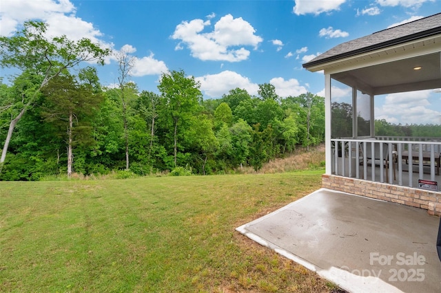 1024 Scotch Meadows Loop Unit 32, Monroe, NC 28110 - view of green lawn with a patio area and a forest view
