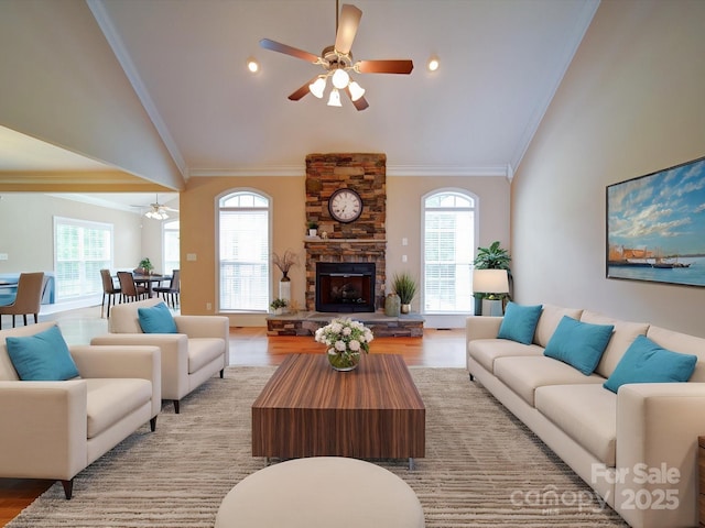 living area featuring a ceiling fan, light wood-style floors, and vaulted ceiling