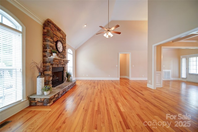 unfurnished living room with a fireplace, light wood-style flooring, visible vents, and ceiling fan