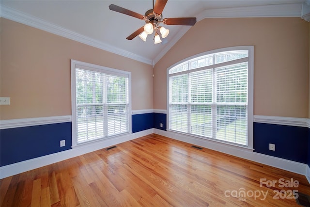 spare room with ceiling fan, lofted ceiling, wood finished floors, and baseboards