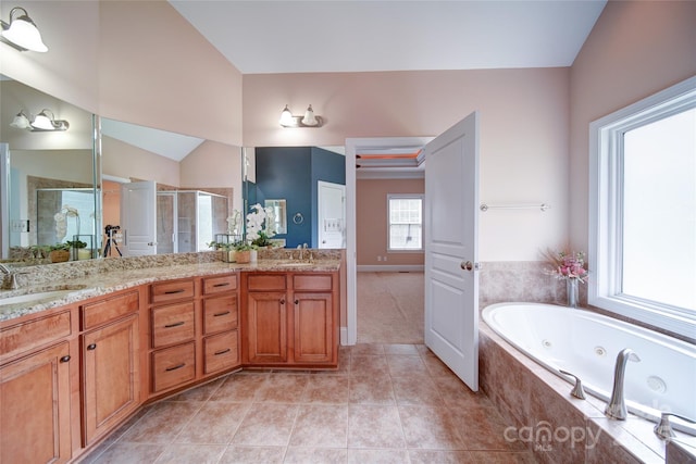 full bath featuring double vanity, vaulted ceiling, a tub with jets, a sink, and a stall shower