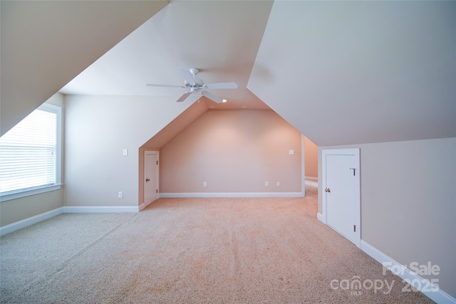bonus room featuring vaulted ceiling, carpet, baseboards, and ceiling fan