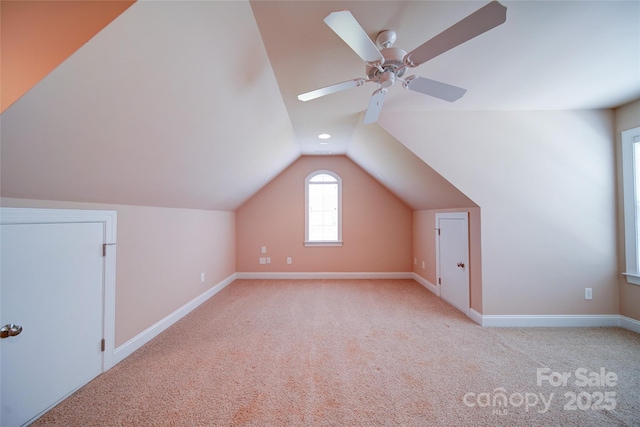 additional living space with lofted ceiling, baseboards, and carpet floors