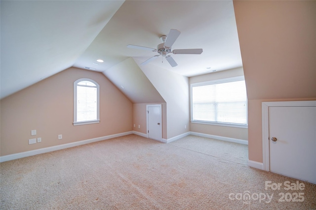 bonus room featuring carpet, lofted ceiling, visible vents, a ceiling fan, and baseboards