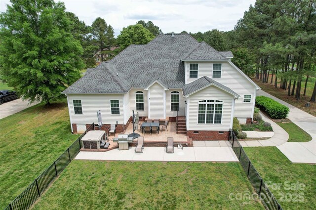 back of house featuring a fenced backyard, crawl space, a patio area, and a yard