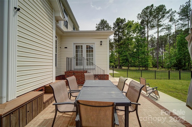view of patio with outdoor dining area and fence