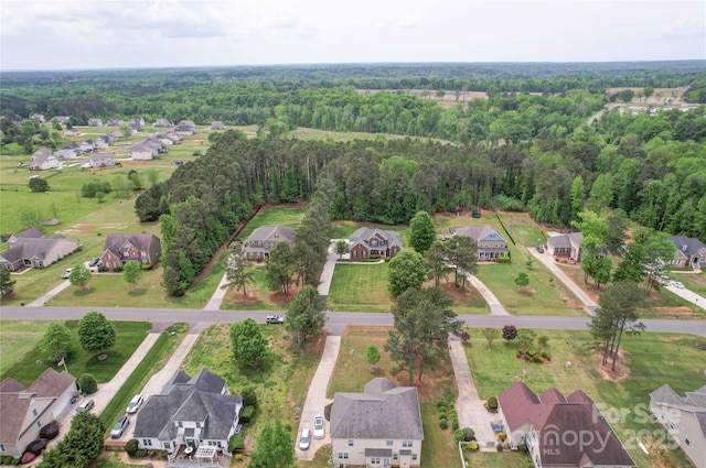 birds eye view of property with a forest view and a residential view