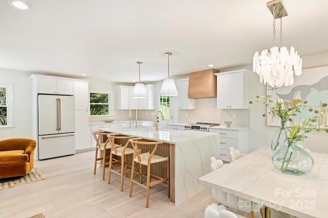 7506 Kilcullen Dr, Charlotte, NC 28270 - kitchen featuring decorative backsplash, white cabinetry, high end white refrigerator, and custom range hood