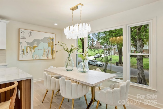 7506 Kilcullen Dr, Charlotte, NC 28270 - dining area featuring recessed lighting, baseboards, light wood-style floors, and an inviting chandelier