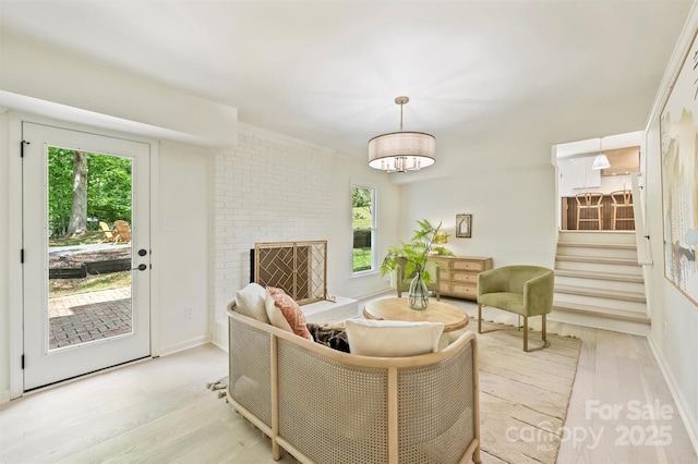 7506 Kilcullen Dr, Charlotte, NC 28270 - living room with a fireplace, baseboards, stairs, and light wood-type flooring