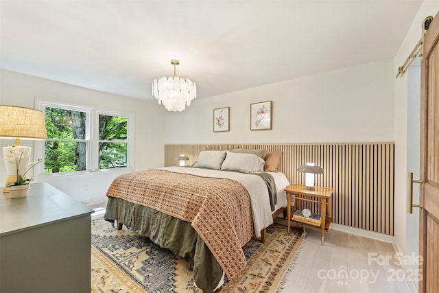7506 Kilcullen Dr, Charlotte, NC 28270 - bedroom featuring light wood-type flooring, baseboards, and a notable chandelier