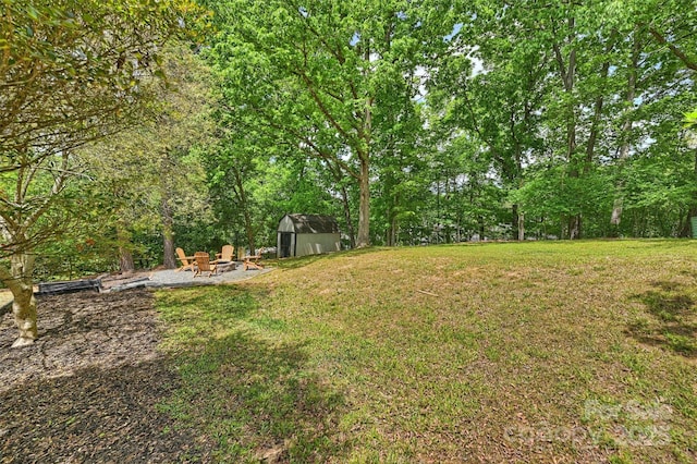 7506 Kilcullen Dr, Charlotte, NC 28270 - view of yard featuring a storage shed, an outbuilding, and an outdoor fire pit