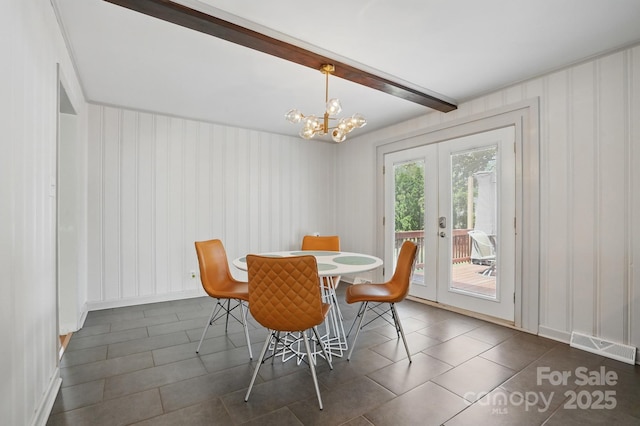 dining room featuring dark tile patterned flooring, an inviting chandelier, french doors, beamed ceiling, and visible vents