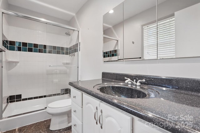 bathroom with recessed lighting, toilet, vanity, and a stall shower