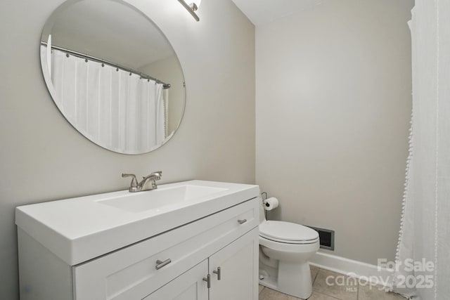 bathroom featuring tile patterned floors, baseboards, vanity, and toilet