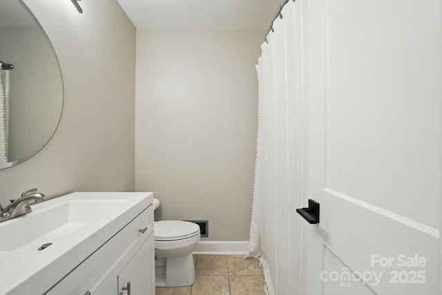 bathroom featuring tile patterned floors, baseboards, vanity, and toilet