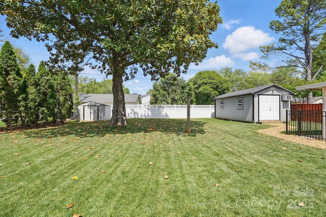 view of yard with a fenced backyard, an outdoor structure, and a storage shed