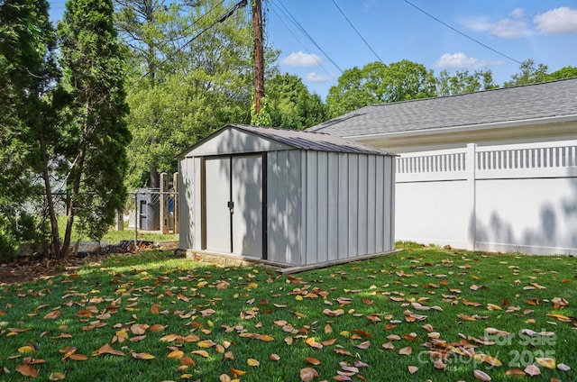 view of shed featuring fence